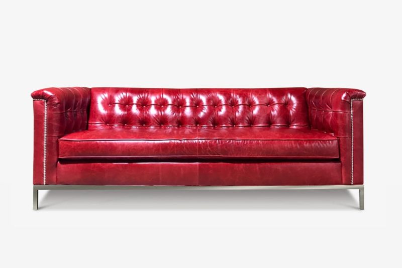 Neil Mid-Century Sofa In Cranberry Leather Shown With Optional Square Tufting & Stainless Steel Legs