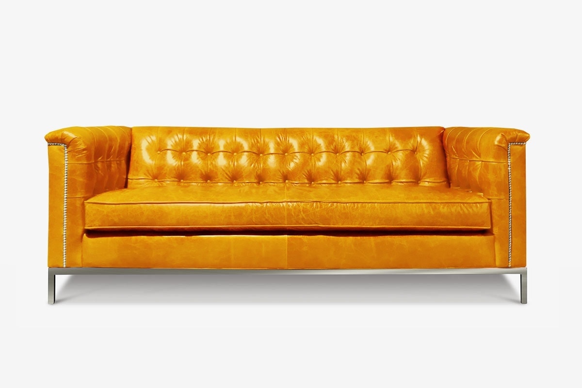 Neil Mid-Century Sofa in Pumpkin Leather Shown with Optional Square Tufting & Stainless Steel Legs